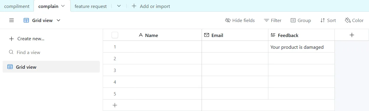 AI customer feedback triage with Airtable, Slack and Gmail: The Airtable base with a table per feedback type, showing a test complaint (name and email covered).